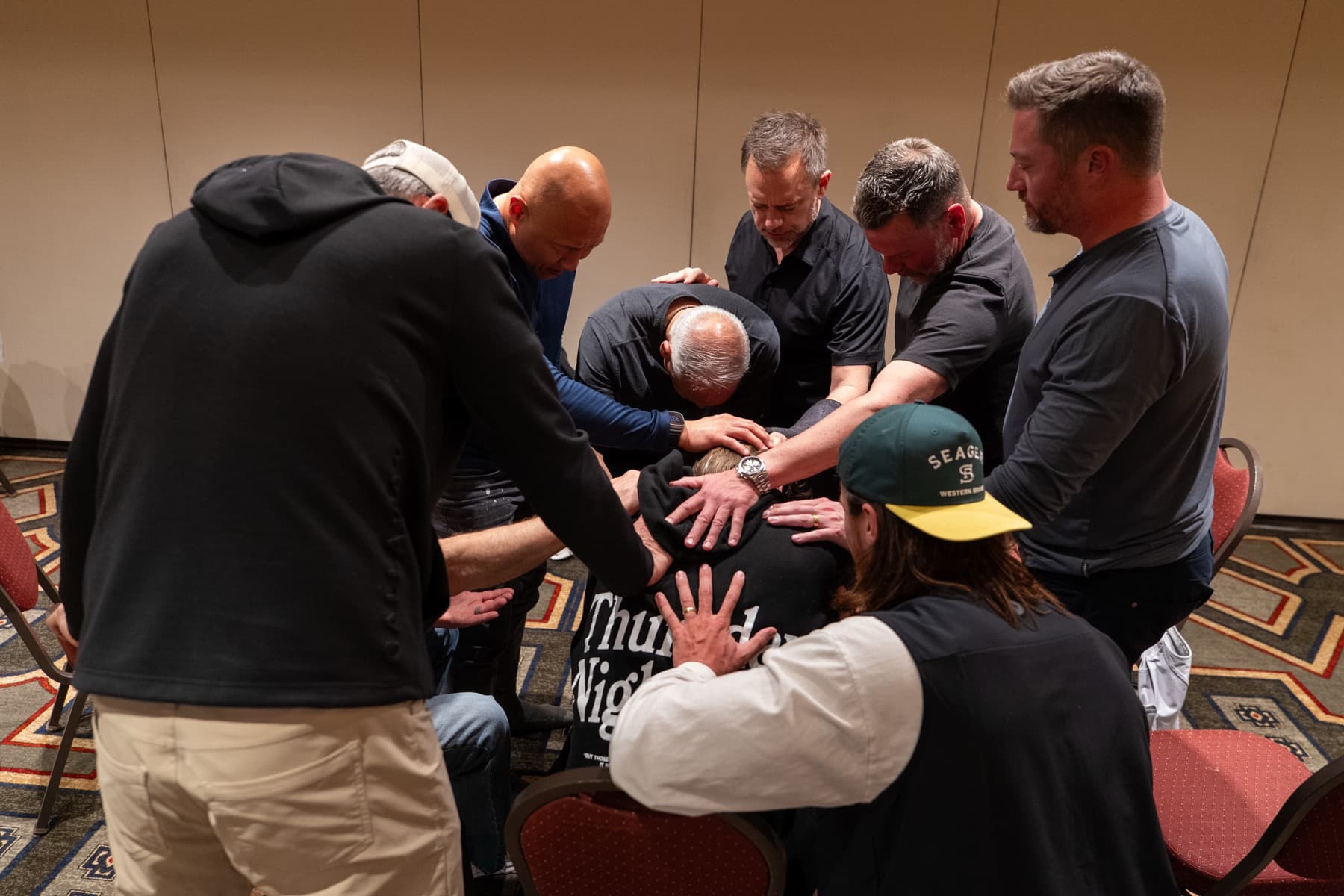 Men gathered in prayer